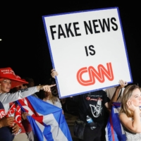 Supporters of former U.S. President Donald Trump stand outside his Mar-a-Lago home in Palm Beach, Florida, on Monday. | REUTERS