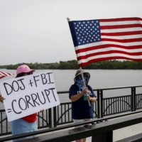 Supporters of former U.S. President Donald Trump protest the FBI raid of his Mar-a-Lago home Tuesday.  | REUTERS