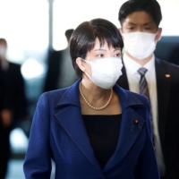 Sanae Takaichi, appointed as the minister in charge of economic security, arrives at the Prime Minister\'s Office Wednesday. | REUTERS