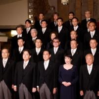 Prime Minister Fumio Kishida and his Cabinet ministers pose for a photo session at his official residence in Tokyo on Wednesday. | POOL / VIA AFP-JIJI