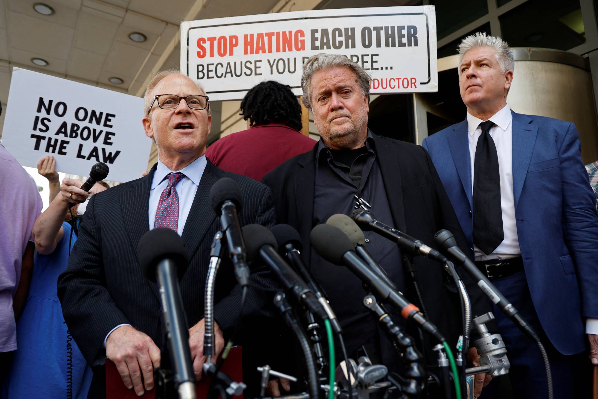 Former White House chief strategist Steve Bannon (center) and his lawyers Evan Corcoran (right) and David Schoen depart after Bannon was found guilty during his trial on contempt of Congress charges, at U.S. District Court in Washington, on July 22. | REUTERS