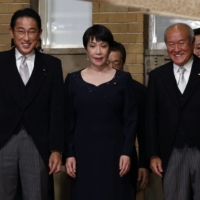 Prime Minister Fumio Kishida with Cabinet members, including economic security minister Sanae Takaichi (center) and finance minister Shunichi Suzuki, following a Cabinet reshuffle Wednesday. | POOL / VIA BLOOMBERG