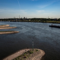 A tanker travels past steel plants while navigating low water levels on the Rhine river in Duisburg, Germany, on Wednesday.  | BLOOMBERG