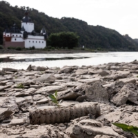 Exposed river bed of the River Rhine near Pfalzgrafenstein castle in Kaub, Germany, on Aug. 4. An extended dry spell at the Rhine — a key hard-coal import route — risks choking Germany\'s energy supply further. | BLOOMBERG