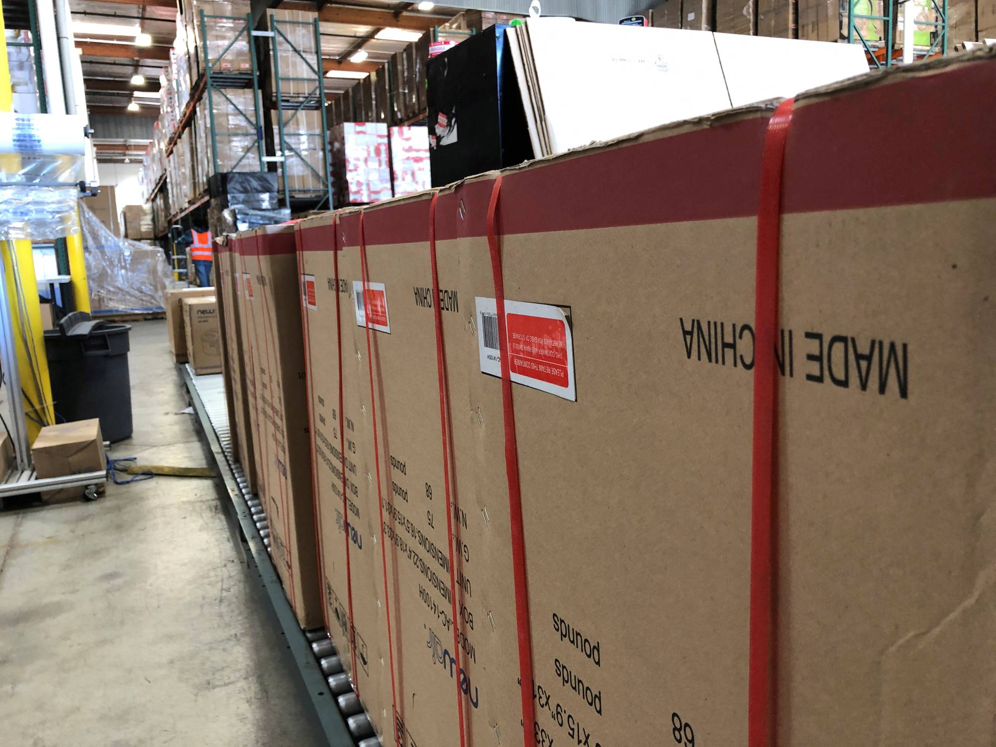 Boxes marked 'Made in China' line floors of warehouse in Cypress, California, in 2019. The tariffs were imposed in 2018 and 2019 by Trump on thousands of Chinese imports valued then at $370 billion to pressure China over its suspected theft of U.S. intellectual property. | REUTERS