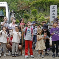 Children blow soap bubbles at Mount Osutaka in Ueno, Gunma Prefecture, on Friday to commemorate the 37th anniversary of the 1985 Japan Airlines plane crash. | KYODO