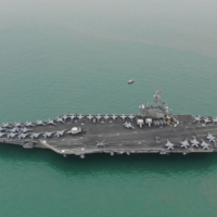 The USS Ronald Reagan aircraft carrier leaves Victoria Harbor after a visit to Hong Kong in November 2018. | CAIXIN MEDIA / VIA REUTERS  