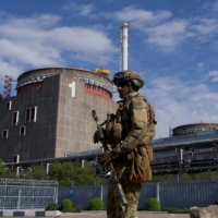 A Russian serviceman on patrol near Ukraine\'s Zaporizhzhia nuclear power plant in May.  | AFP-JIJI