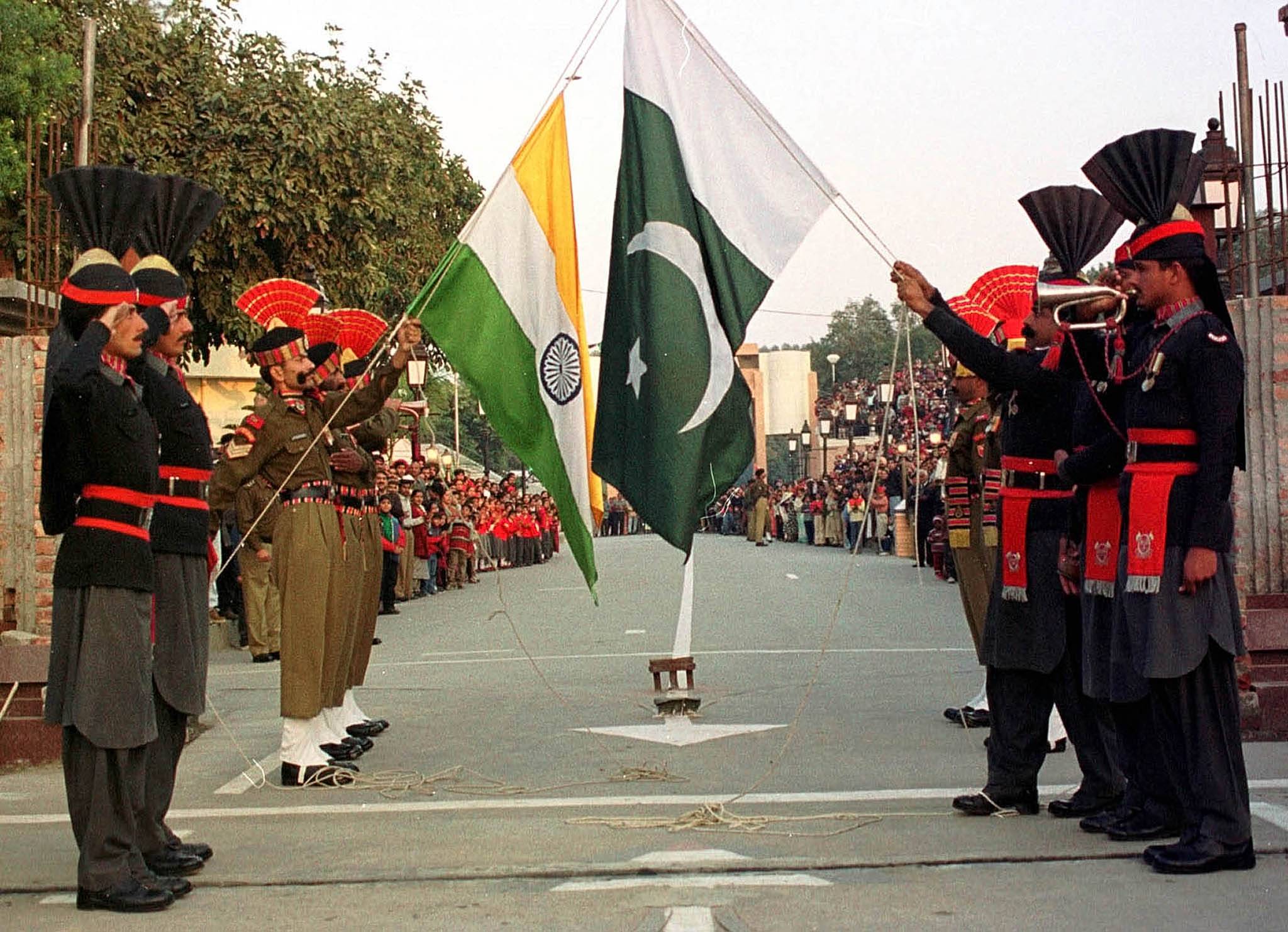Pakistani border guards (right) and their Indian counterparts take part in the daily closing ceremony of the Wagah border crossing near Lahore, the provincial capitalof Punjab, Pakistan.  |  REUTERS