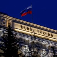 The national flag flies over the Russian Central Bank headquarters in Moscow on May 27. Starting Monday, the Moscow exchange will allow trading in debt securities for investors from countries that haven’t imposed sanctions on Russia. | REUTERS