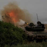 Ukrainian servicemen fire toward Russian troops at a position in Donetsk region of Ukraine on Friday. | REUTERS