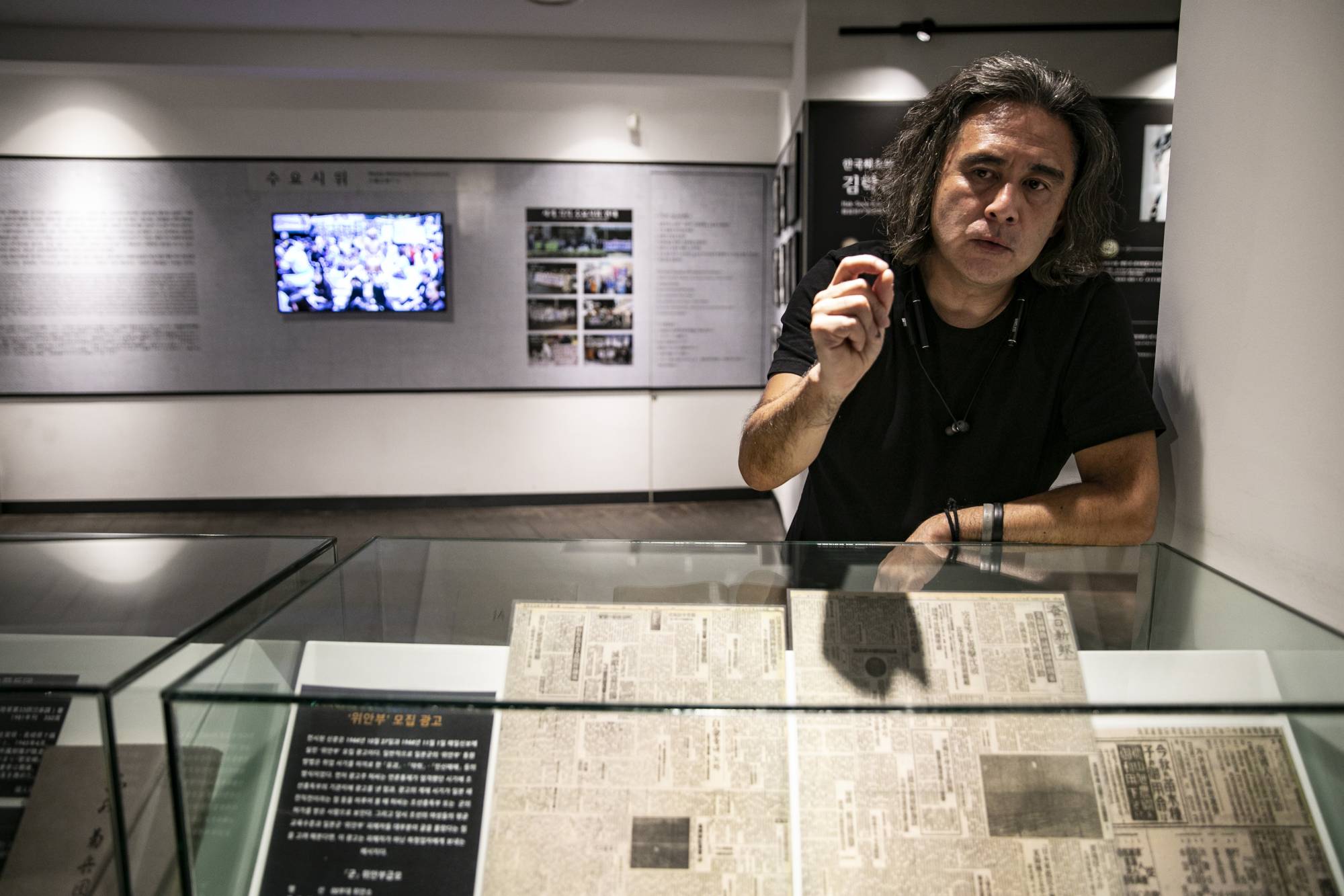 The Japanese photographer Tsukasa Yajima at the history museum of the House of Sharing, a shelter for former 