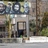 Members of the United Nations Interim Force in Lebanon and the Lebanese Army sit in the main square of the southern Lebanese border village of Yaroun, on Saturday. | AFP-JIJI