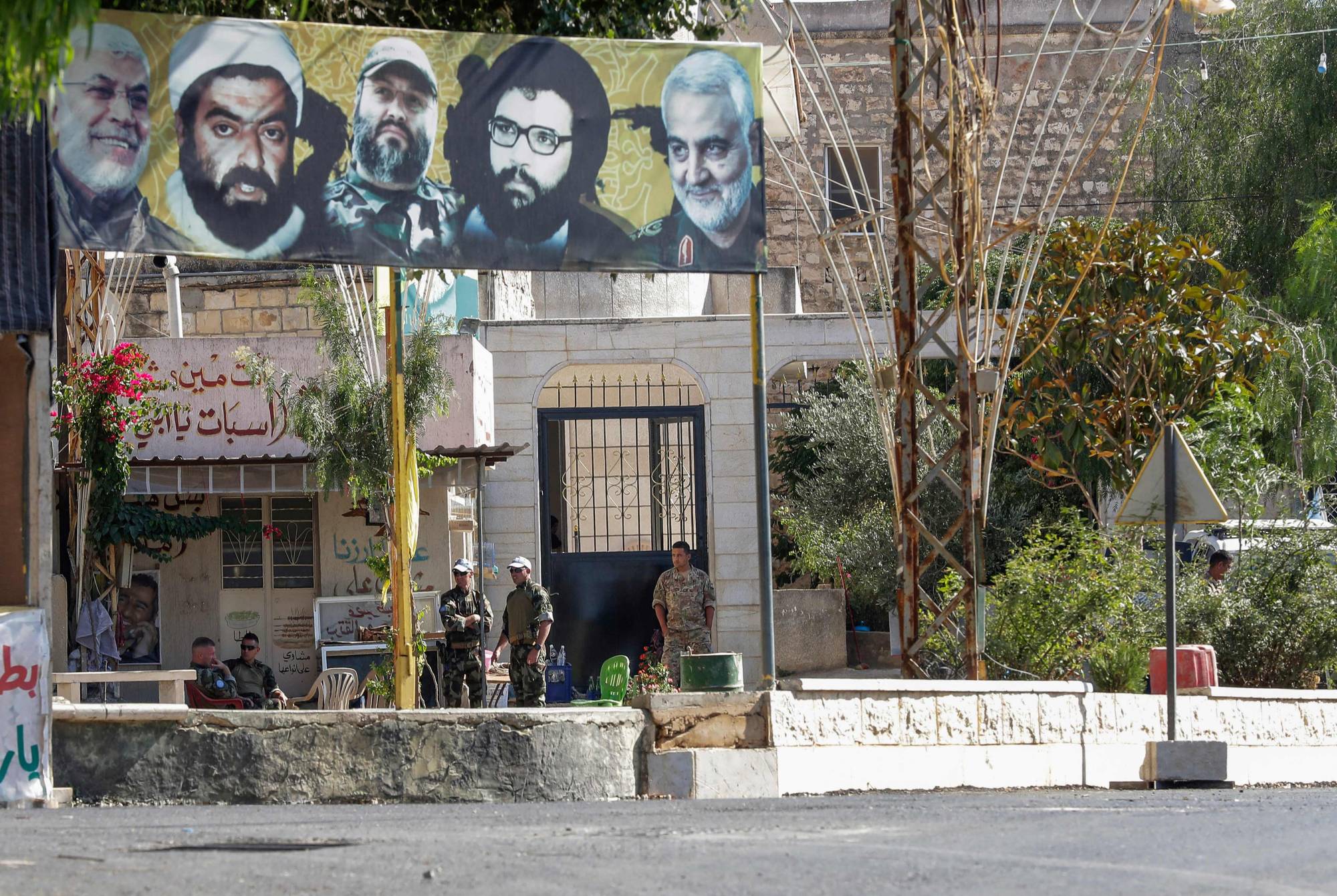Members of the United Nations Interim Force in Lebanon and the Lebanese Army sit in the main square of the southern Lebanese border village of Yaroun, on Saturday. | AFP-JIJI