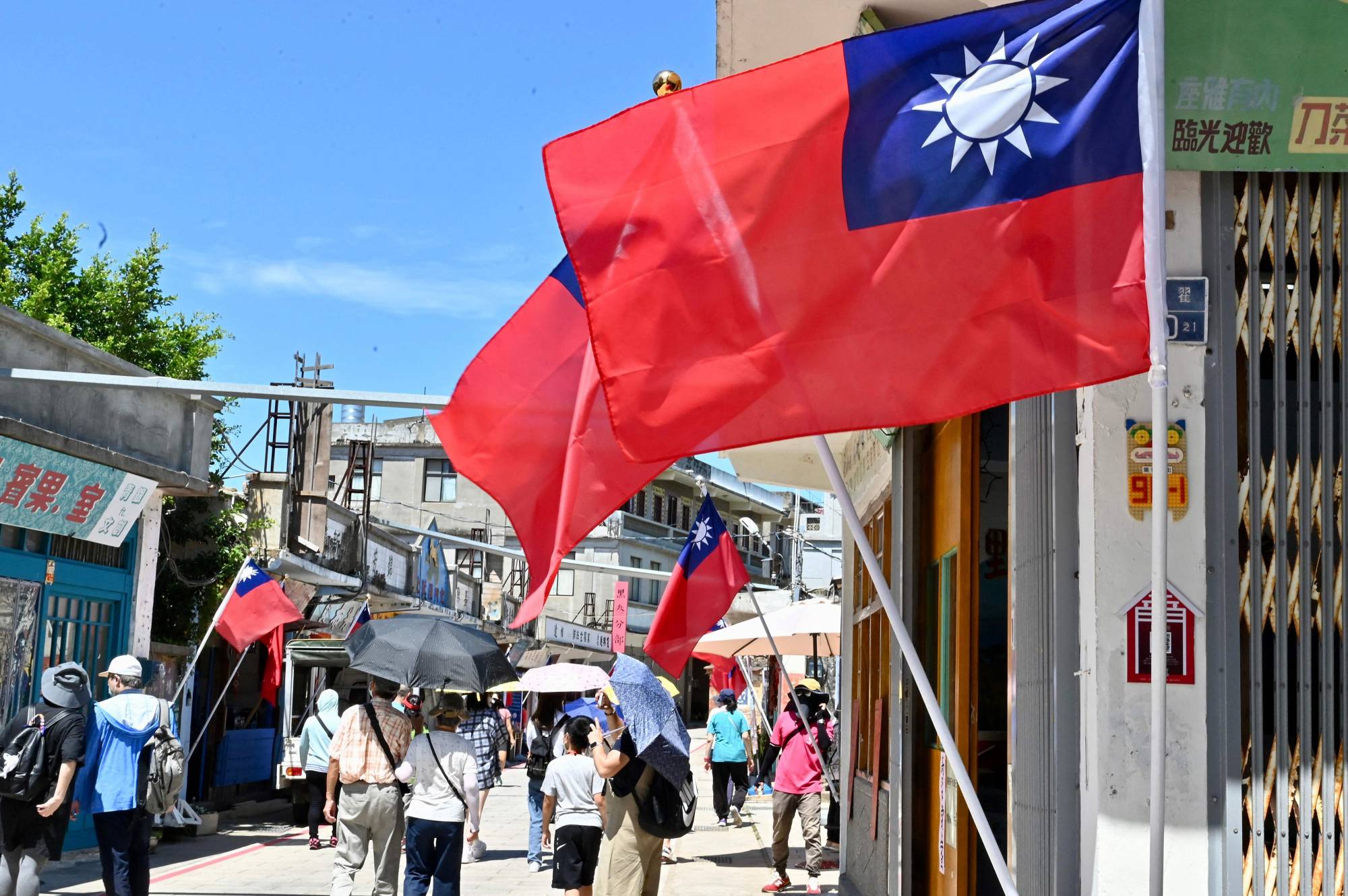 Tourists walk along a street on Taiwan's Kinmen islands on Thursday. | AFP-JIJI