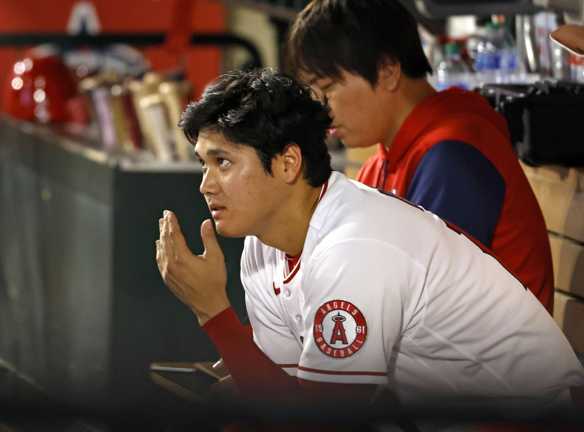 Angels star Shohei Ohtani watches from the bench after pitching six innings against the Mariners in Anaheim, California, on Monday. | KYODO