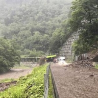 A road covered with mud amid heavy rain in Hidaka, Hokkaido, on Tuesday | LAND MINISTRY / VIA KYODO