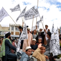 Taliban fighters and supporters celebrate the one year anniversary of the group’s return to power in Afghanistan in the city of Kandahar on Monday.  | AFP-JIJI