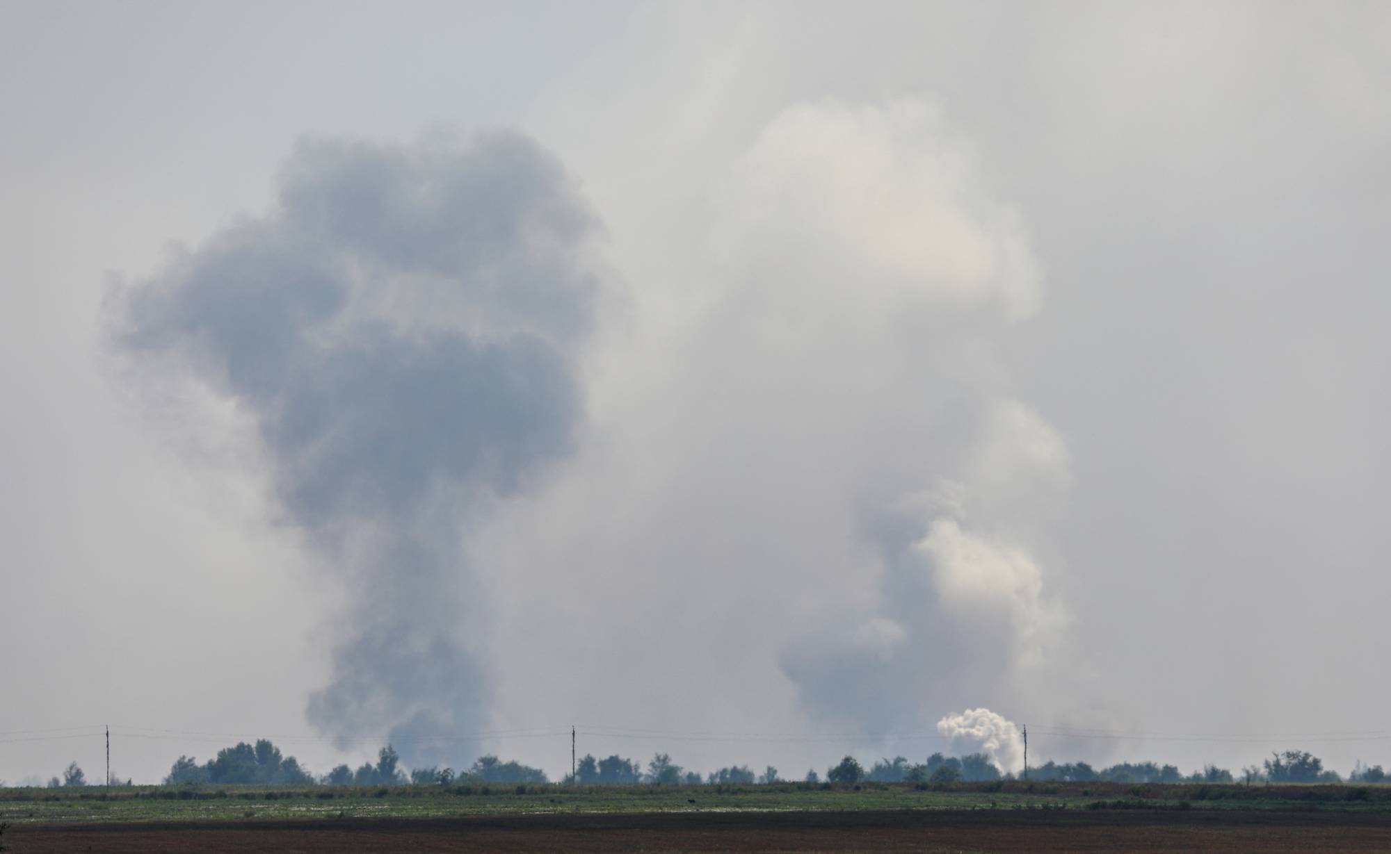 Smoke rises from explosions at a Russian ammunition depot in the Dzhankoi district of Crimea on Tuesday. | REUTERS