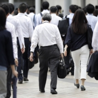 More large Japanese companies appear willing to raise wages to attract workers, a survey has found. | BLOOMBERG