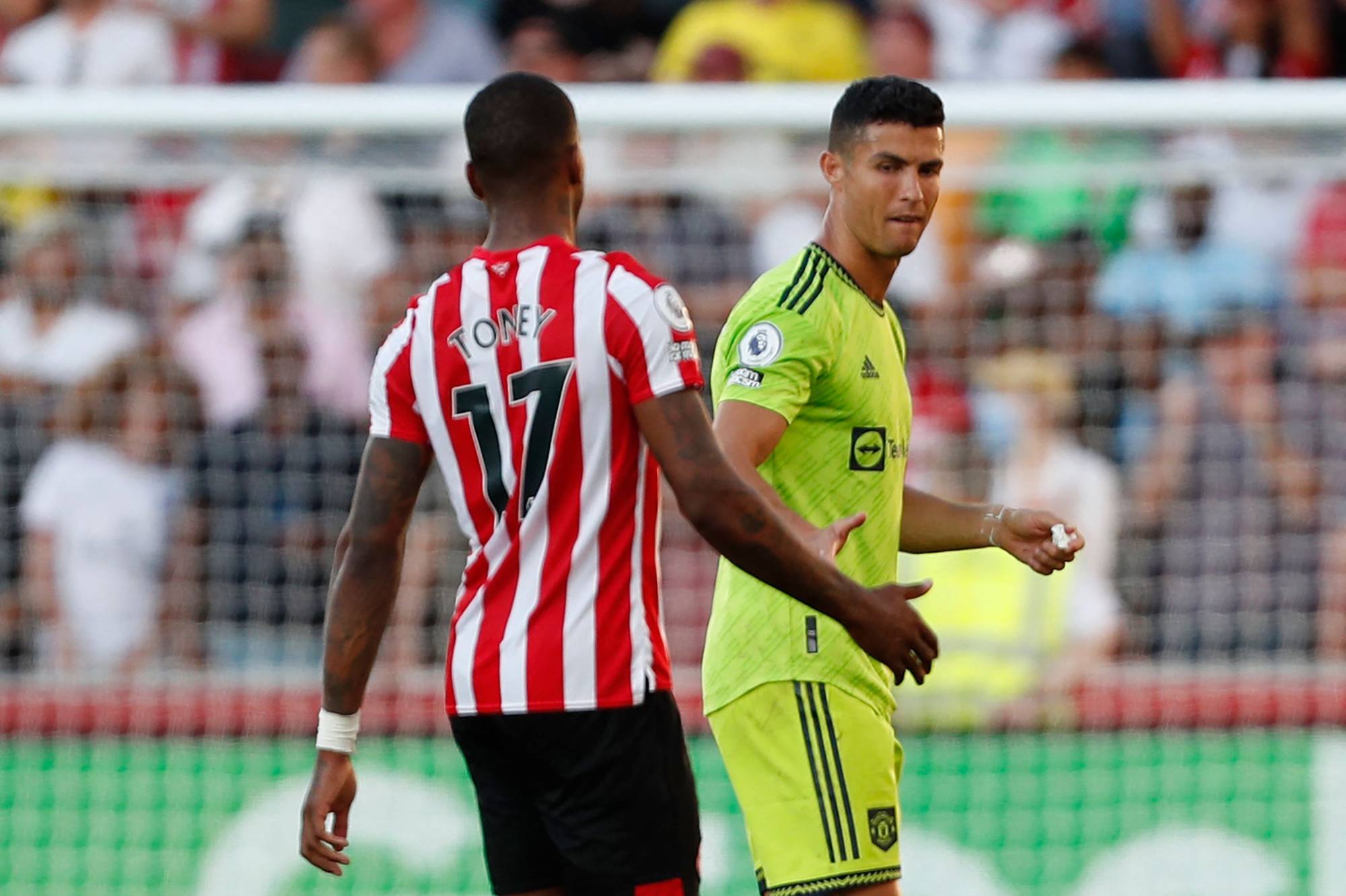 Manchester United striker Cristiano Ronaldo (right) shake hands with Brentford striker Ivan Toney. United lost the match 4-0, giving lowly Brentford its first victory over the team since 1938. | AFP-JIJI