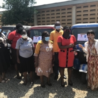 UNDP staff member Yoko Reikan (right) hands over keys to vehicles that will be used by the Ghana Health Service to support remote communities. | UNDP