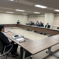 Justice Minister Yasuhiro Hanashi (back center) and senior officials from various ministries hold a meeting on Thursday in Tokyo to discuss steps to support victims of the Unification Church. | KANAKO TAKAHARA
