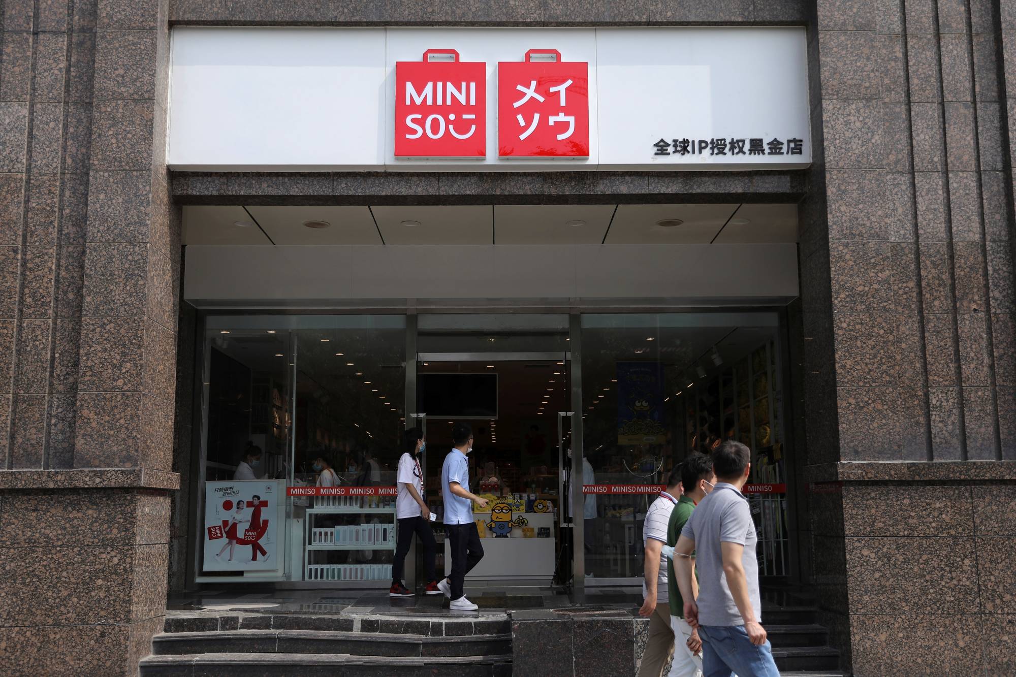People walk past a Miniso store in Beijing on Sept. 13. | REUTERS