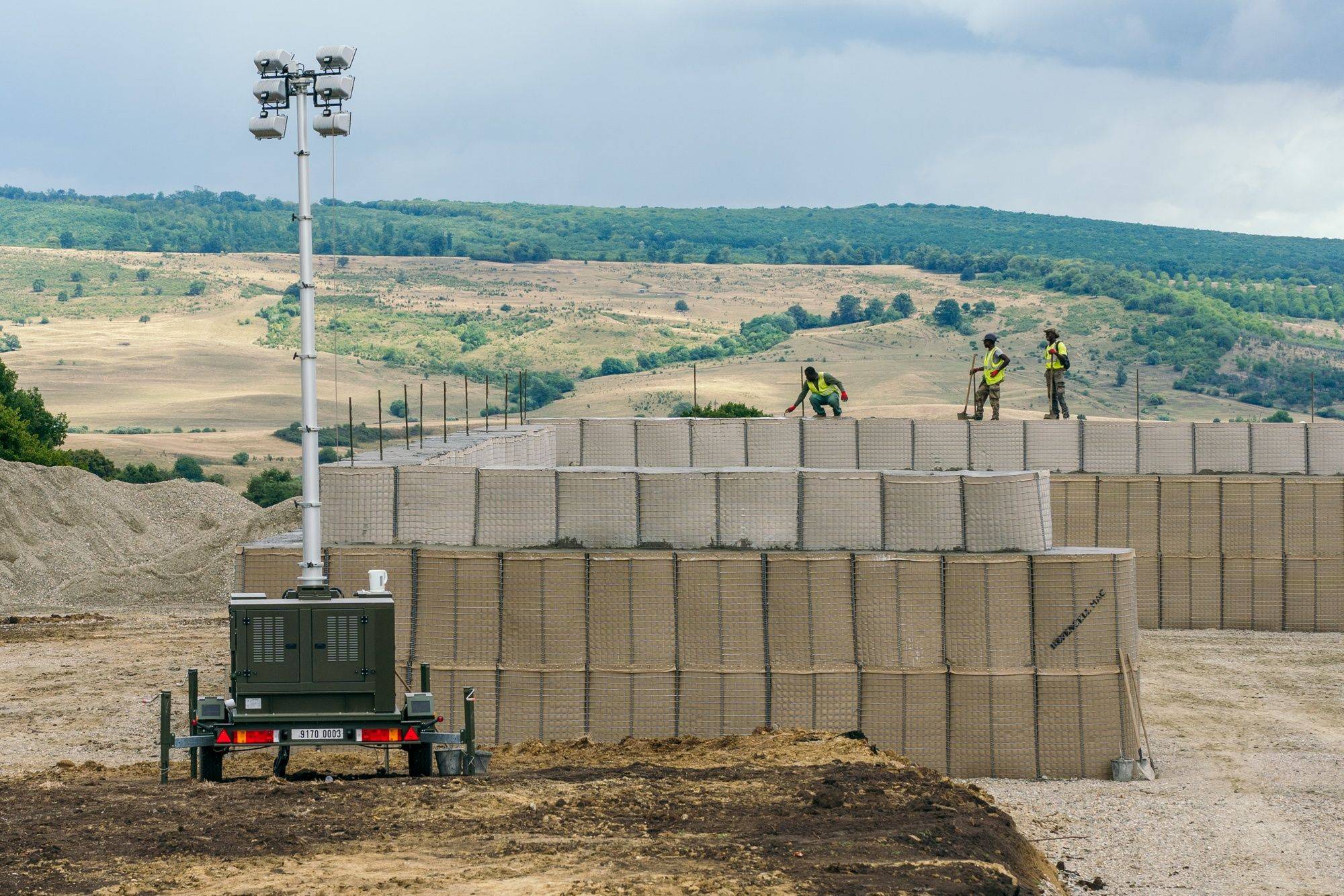 Soldiers from the NATO Battle Group Forward Presence work on the base construction site at the Getica National Joint Training Center in Cincu, Romania, on Aug. 1. | BLOOMBERG