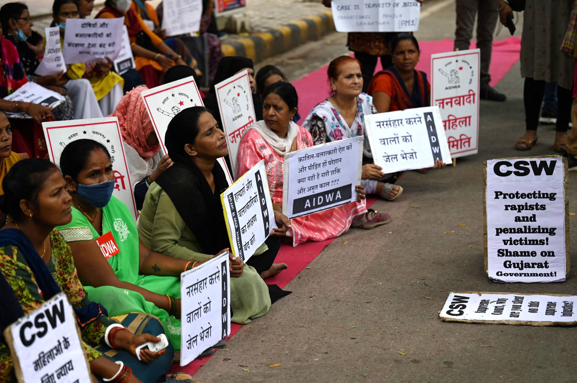 Activists hold placards during a protest in New Delhi on Thursday against the release of men convicted of gang-raping Bilkis Bano in 2002. | AFP-JIJI