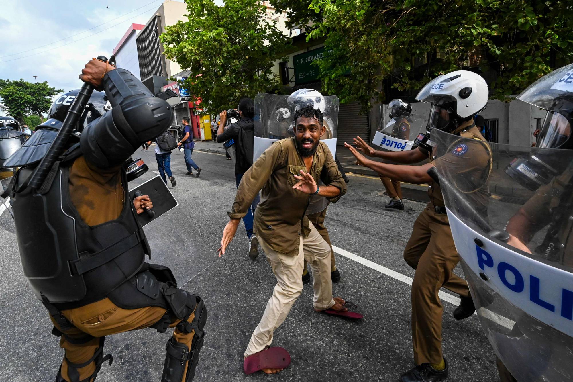 A Sri Lankan university student clashes with police during a demonstration in Colombo on Thursday.  | AFP-JIJI