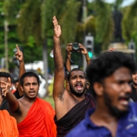 Sri Lankans take part in a demonstration in Colombo on Thursday.  | AFP-JIJI