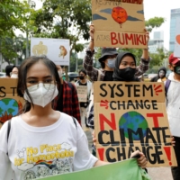 Activists take part in a protest urging governments to act against climate change and social injustice in Jakarta on March 25.  | REUTERS