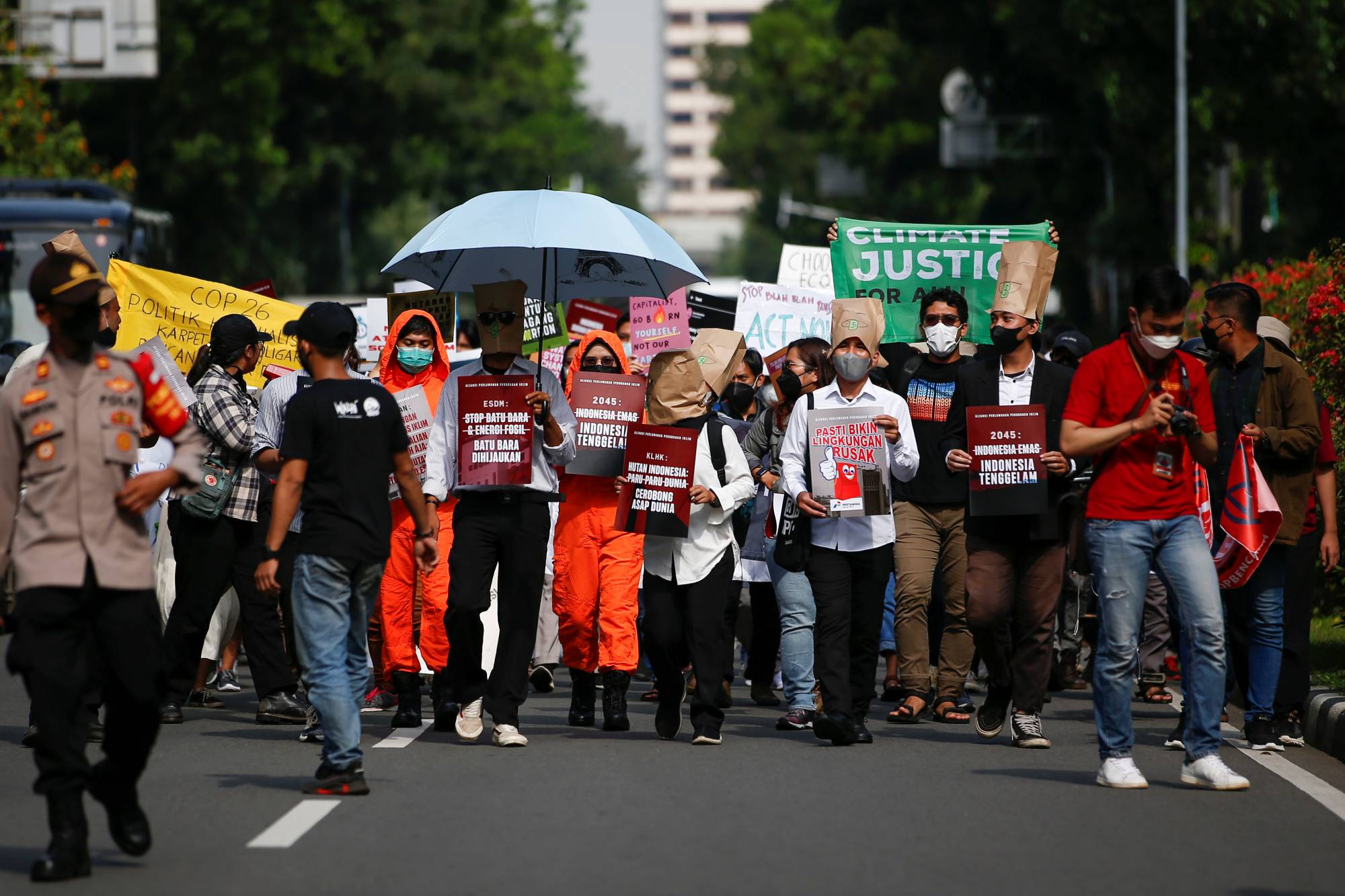 Activists carrying placards take part in a rally asking for climate justice in Jakarta in November 2021. | Reuters