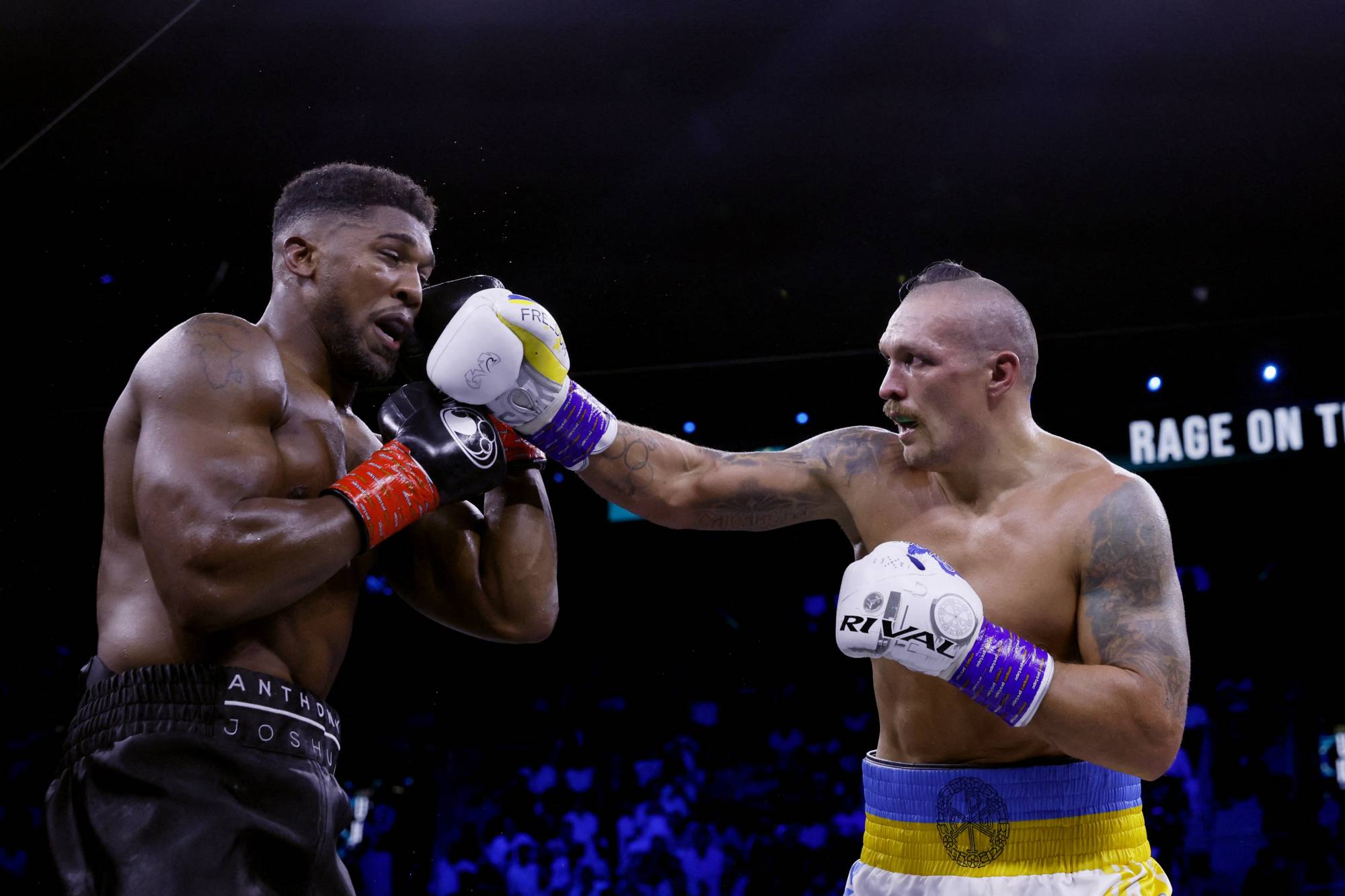 Oleksandr Usyk (right) pressures Anthony Joshua during their world heavyweight title fight in Jeddah on Saturday. | Reuters
