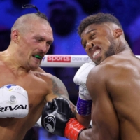 Oleksandr Usyk punches Anthony Joshua during their bout for the WBA, WBO, IBO and IBF titles in Jeddah on Aug. 20. | AFP-JIJI