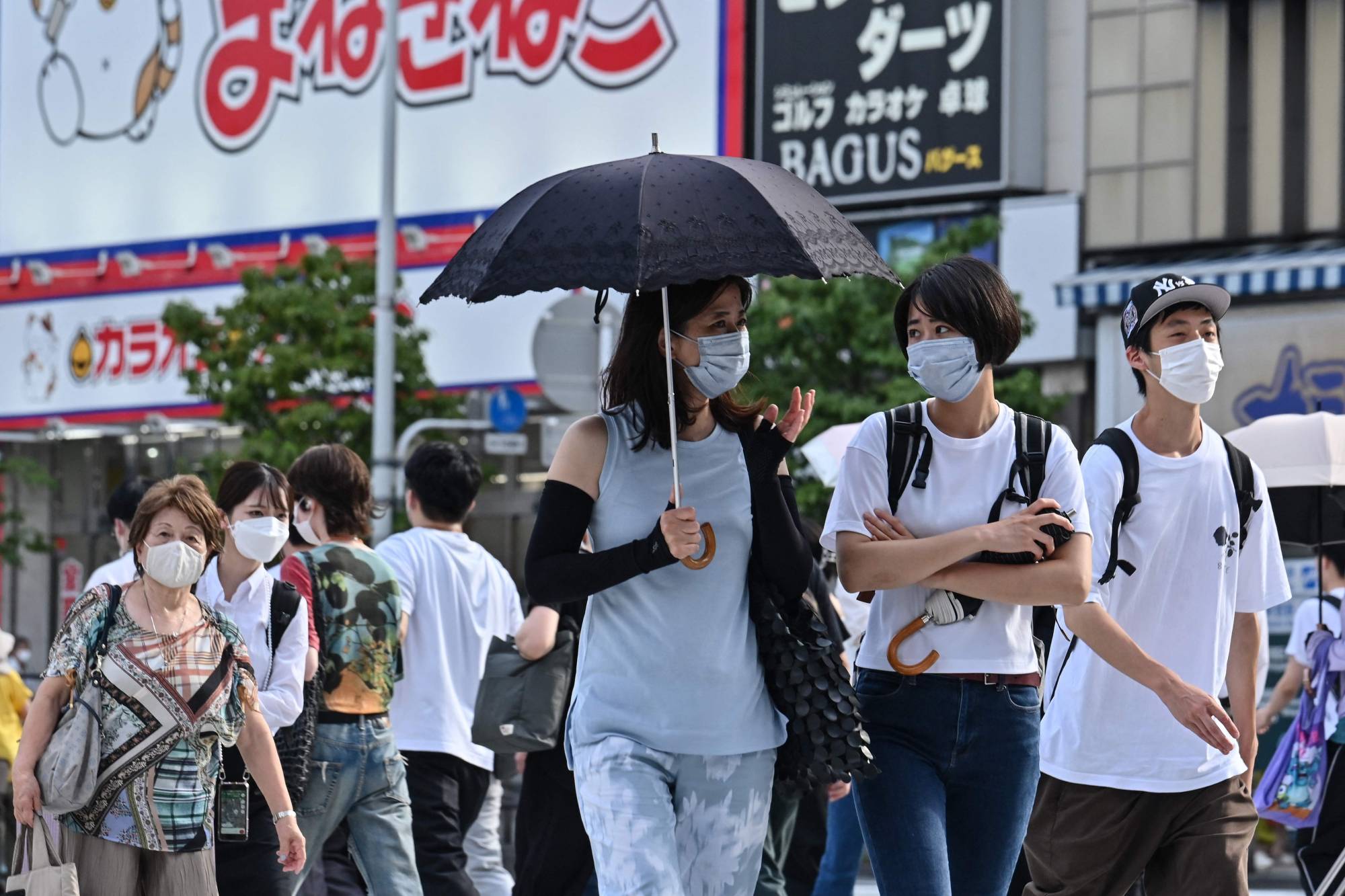 People cross a street in the Shinjuku district of Tokyo on Tuesday. | AFP-JIJI