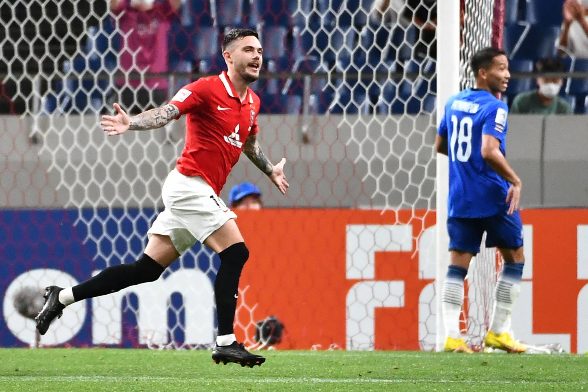 Urawa forward David Moberg (left) celebrates after scoring the team's opening goal against BG Pathum during their Asian Champions League semifinal in Saitama on Monday. | AFP-JIJI