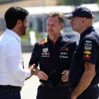 Red Bull Team Principal Christian Horner (center) says he mas made a \"long-term commitment\" to the Formula One team. | REUTERS