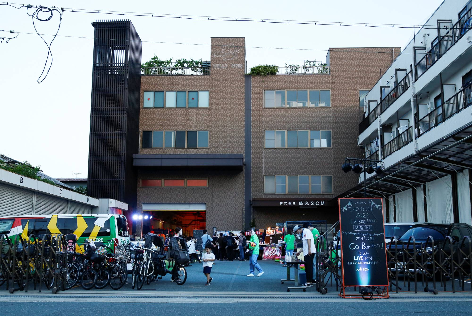 People attend a drink, chat and music live event hosted by a factory in Higashiosaka on June 24. | Reuters