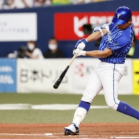 BayStars pitcher Shota Imanaga singles in a run against the Tigers during the second inning in Osaka on Tuesday. | KYODO