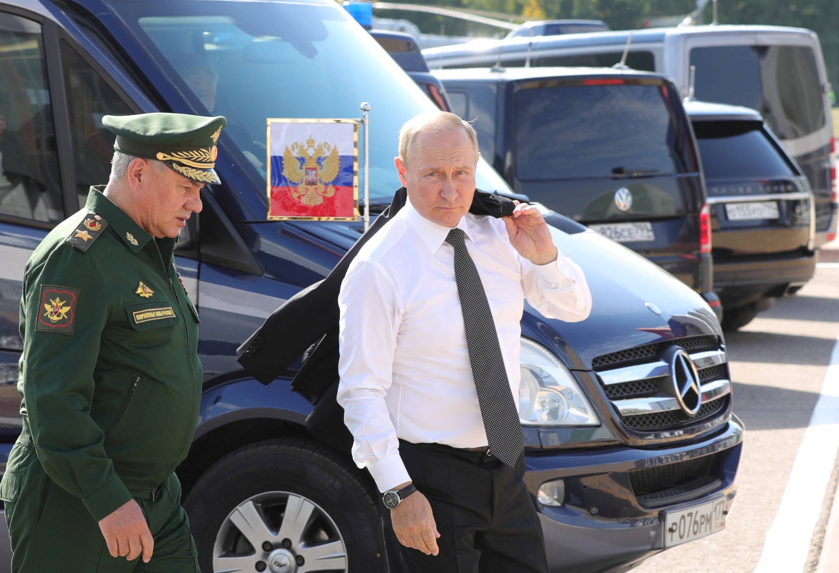 Russian President Vladimir Putin (right) and Defense Minister Sergei Shoigu attend the international military-technical forum Army-2022 at Patriot Congress and Exhibition Center in Moscow, on Aug. 15. | SPUTNIK / KREMLIN / VIA REUTERS 