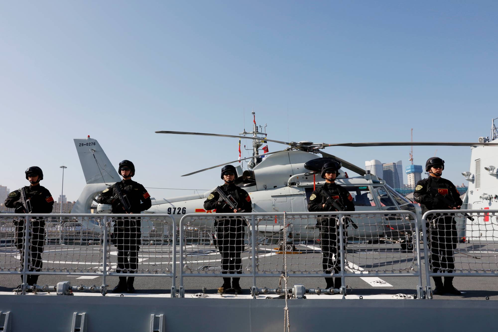 Chinese People's Liberation Army (PLA) Navy soldiers stand guard on the guided missile destroyer Xining as they depart for an escort mission in the Gulf of Aden and off the Somali coast, at a port in Qingdao, China's Shandong province, in August 2019. | REUTERS