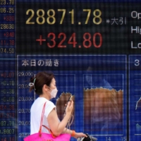A share price board showing the closing numbers for the Tokyo Stock Exchange in Tokyo on Aug. 15 | AFP-JIJI