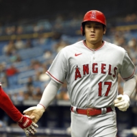 Shohei Ohtani is congratulated after scoring a run during the Angels\' loss to the Rays in St. Petersburg, Florida, on Thursday. | USA TODAY / VIA REUTERS
