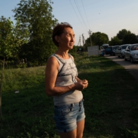 Olena Bondarchyk, 46, waits with others fleeing Enerhodar, Ukraine, and other Russian-occupied territories, at a Ukrainian controlled checkpoint as shelling continues around the Zaporizhzhia nuclear power plant in Ukraine on Sunday. | LYNSEY ADDARIO / THE NEW YORK TIMES