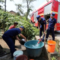 Firefighters deliver water to residents due to a shortage amid heat wave conditions in Loudi, in China\'s central Hunan province, on Wednesday. | AFP-JIJI