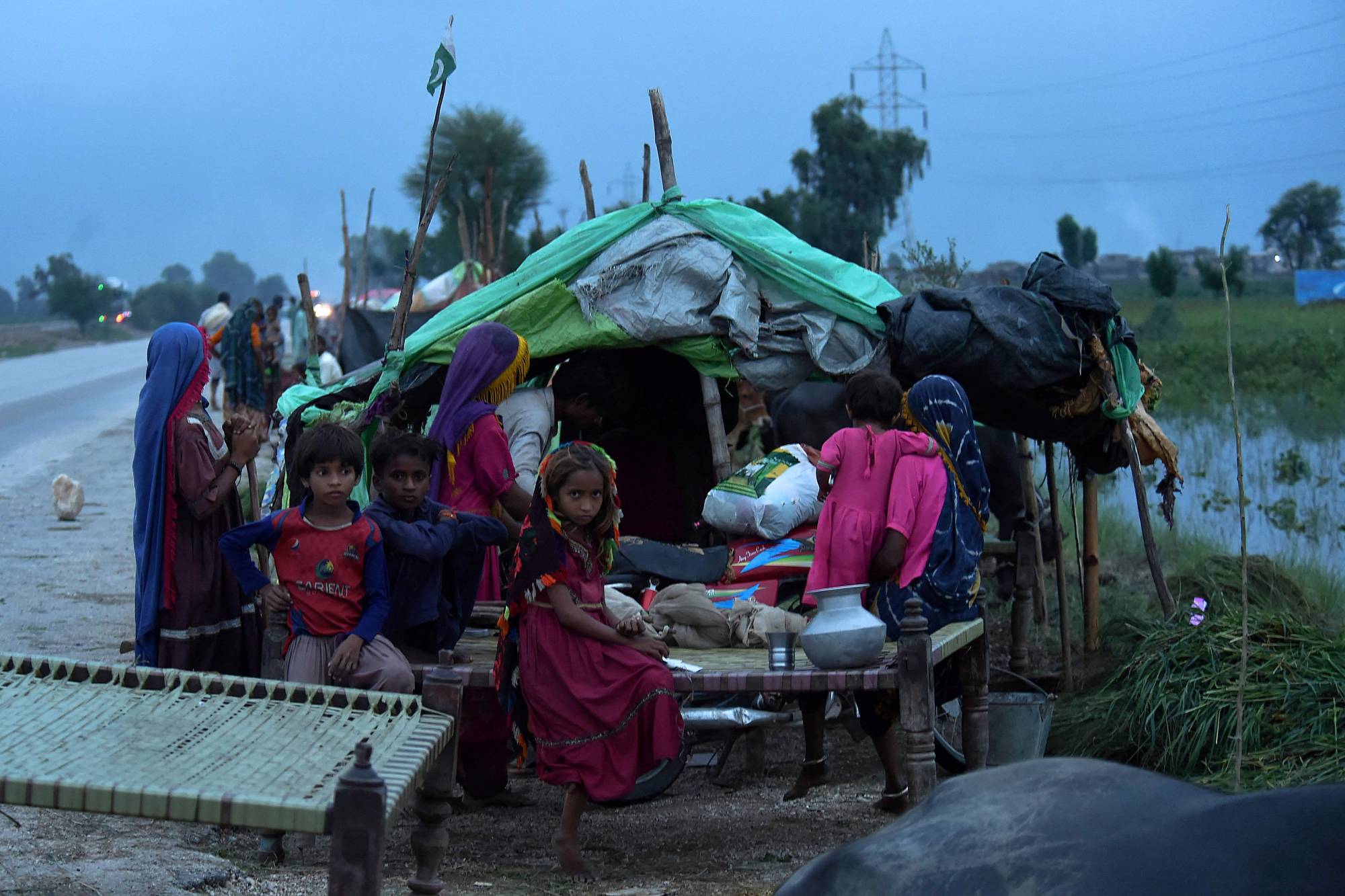 Flood-hit people take shelter at a makeshift camp after heavy monsoon rainfall in Sindh province, southern Pakistan, on Thursday. | AFP-Jiji