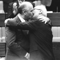 Soviet leader Mikhail Gorbachev (left) congratulates East German leader Erich Honecker with a fraternal hug and kiss after Honecker\'s re-election as general secretary of the Communist Party Congress in East Berlin in April 1986. | GABY SOMMER / REUTERS