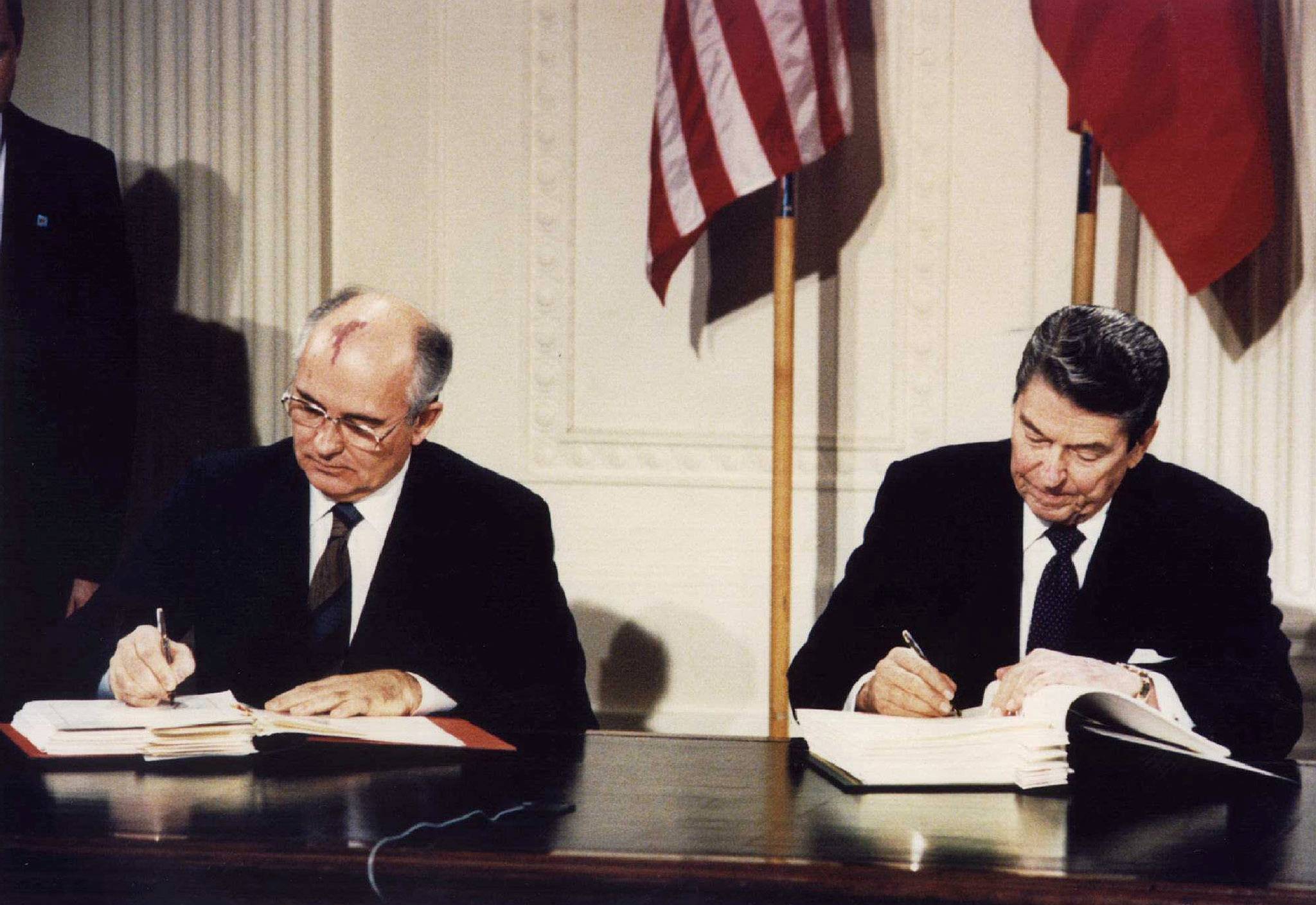 U.S. President Ronald Reagan and Soviet leader Mikhail Gorbachev sign the Intermediate-Range Nuclear Forces (INF) treaty in Washington on Dec. 8 1987. | Dennis Paquin / REUTERS